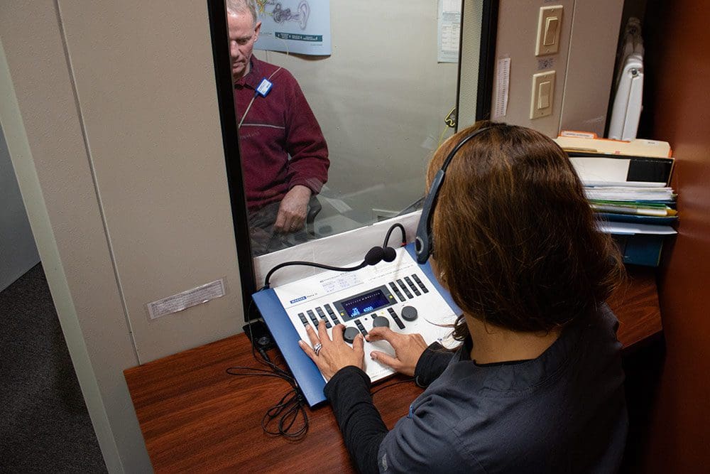 A person in a hearing sound booth. 